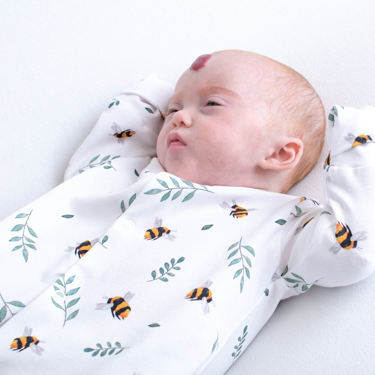 Baby sleepsuit with bees and botanical plants
